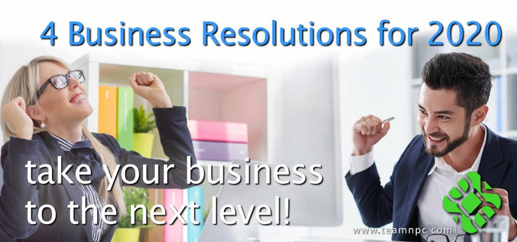 Happy male and female business person cheering in front of computer